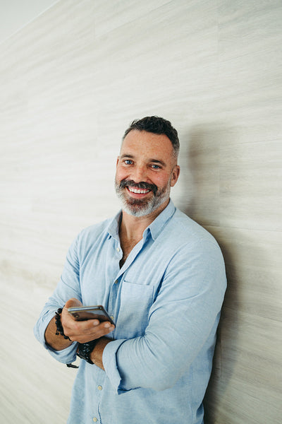 Cheerful entrepreneur smiling at the camera in an office