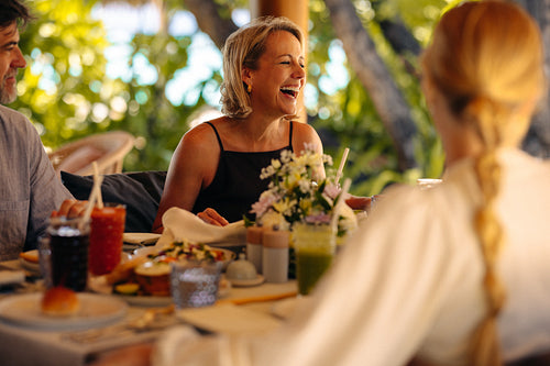 Joyful family gathers for a delightful holiday breakfast amidst a lush green backdrop