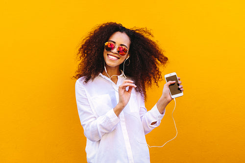 African girl listening music and dancing