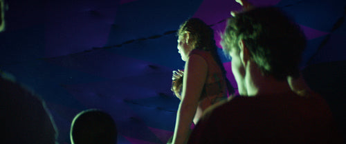Woman dancing on shoulders at a music festival
