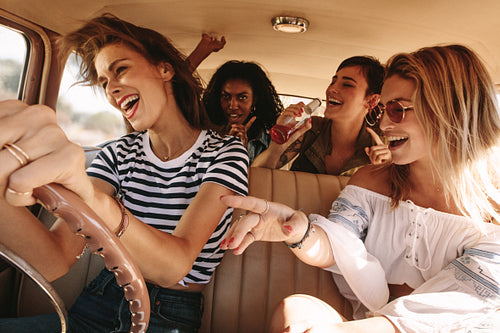 Friends traveling in car and having fun