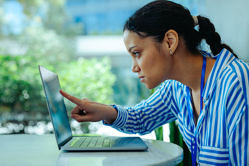 Focused corporate accountant analyzing data on laptop