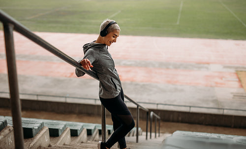 Woman standing on the stairs of a stadium
