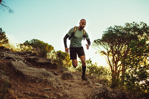 Man running on a rocky mountain trail