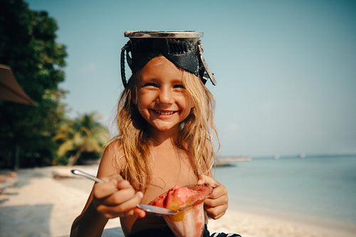 Happy child enjoying ice cream on a tropical island holiday at the beach