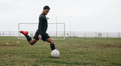 Soccer player practicing on field