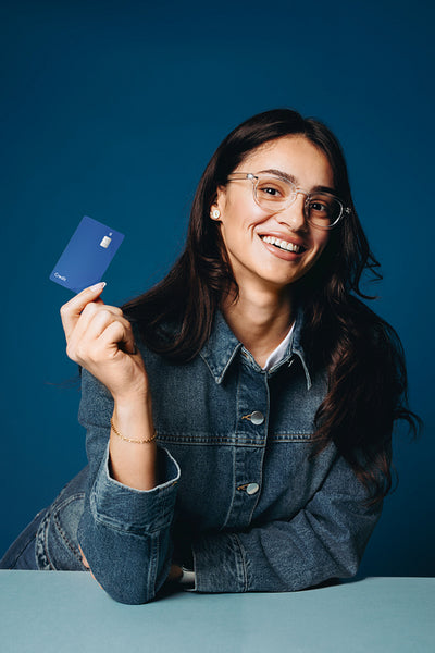 Woman holding credit card in banking finance portrait studio