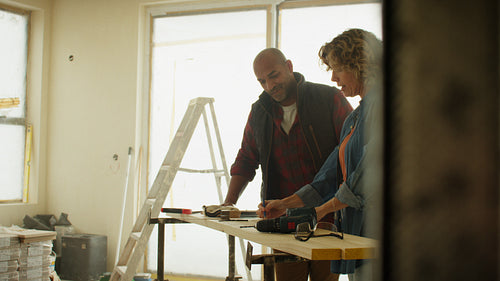 Focused teamwork: Mature couple discussing home renovation plans