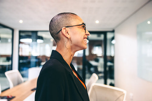 Cheerful businesswoman smiling in a modern workplace