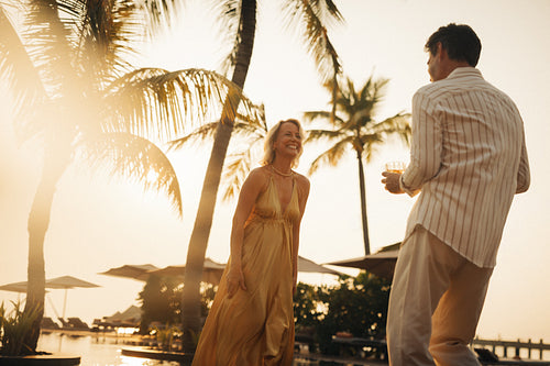 Couple enjoying vacation at holiday resort at sunset