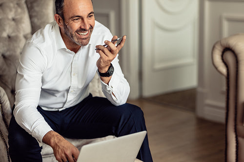 Businessman working from hotel room on business trip