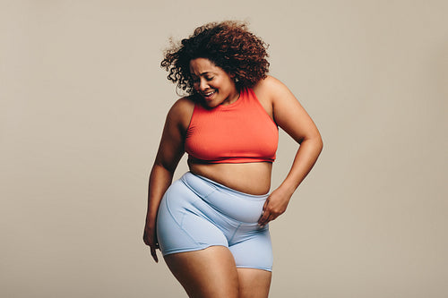Confident plus size woman celebrating her body with a dance