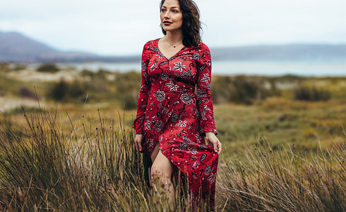 Woman in red dress exploring the nature