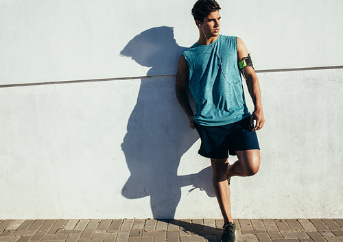 Male runner relaxing after workout