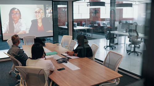 Celebrating accomplishments over a video conference: Business people clapping in an online meeting