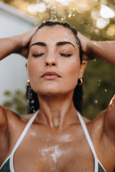 Attractive woman showering outdoors