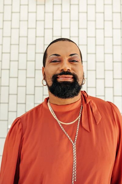 Cheerful drag queen looking at the camera against a white background