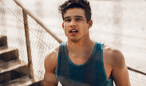 Muscular young man taking a break after workout