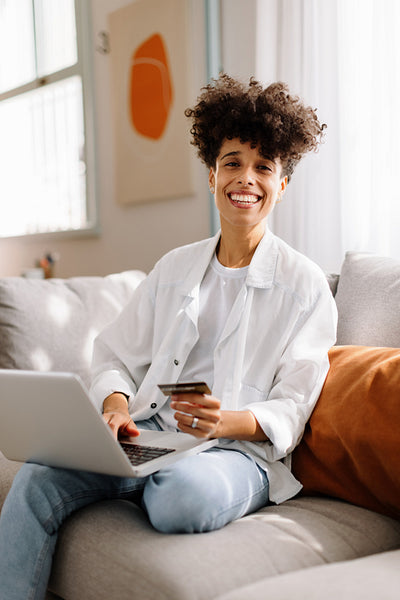 Happy young woman enjoying an online sale at home