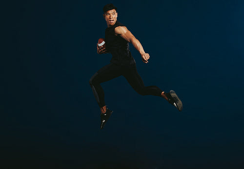 American football player running with ball