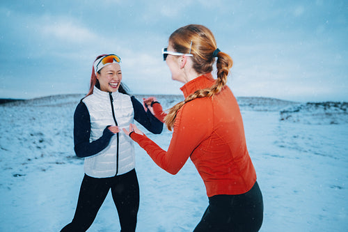 Women turn winter running into a playful outdoor fitness moment