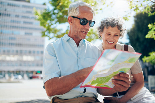 Senior couple looking at city map
