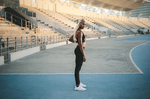 Athlete standing near the stands in a stadium