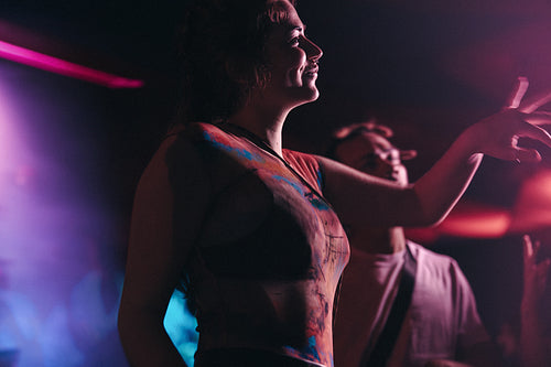 Woman enjoying the night with her friends at a music concert