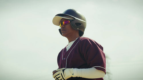Baseball player in batting gear awaits action on the field