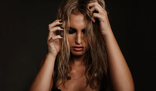 Beautiful young woman posing on black background