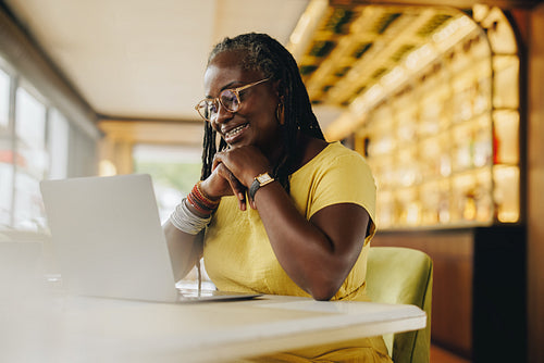 Black businesswoman having a virtual meeting in a cafe
