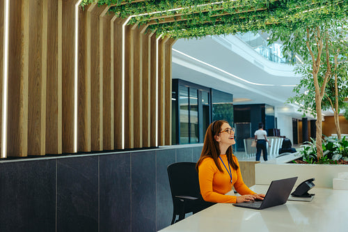 Friendly receptionist working in a modern office environment