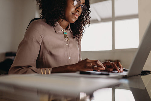 Woman entrepreneur working from home on laptop