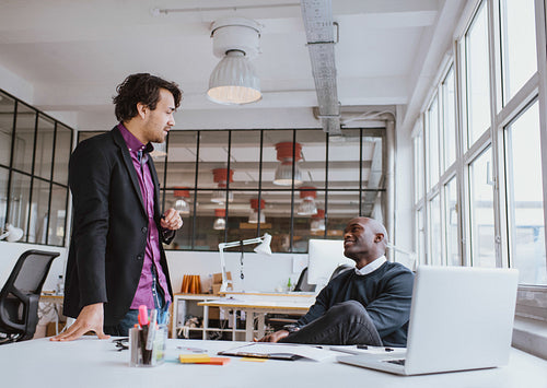 Two young office workers having a casual meeting