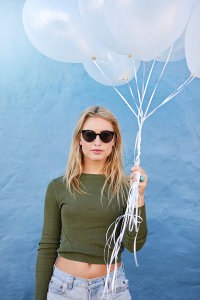 Pretty young woman with white balloons