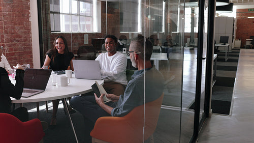 Business people having a meeting in a modern office, discussing ideas and solutions
