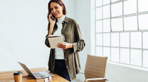 Business woman communicating with her clients on the phone
