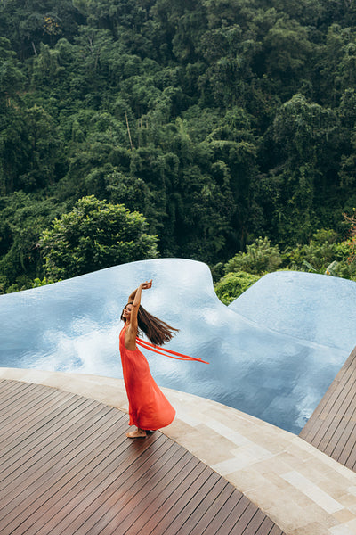 Young woman at poolside looking happy