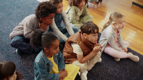 Learning the alphabet through song and rhyme: Primary school children engaging in a phonetics lesson in a classroom