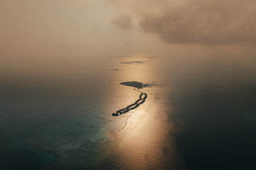 Maldives islands at sunset with scenic ocean and coral reefs