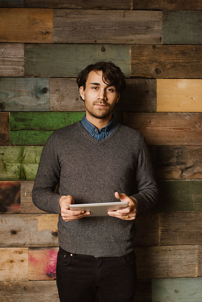 Confident young man holding a digital tablet in office