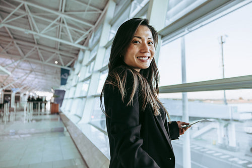 Woman waiting for flight at airport terminal