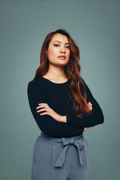 Strong independent young woman standing in a studio