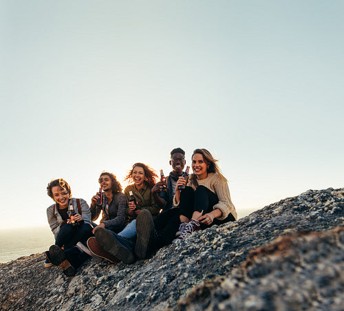 Multi-ethnic friends partying on mountain top