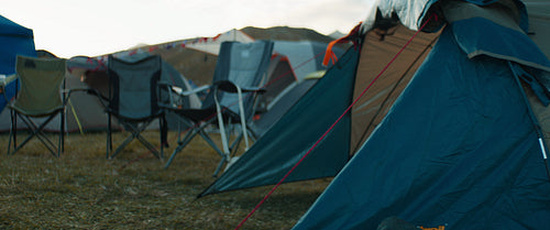 Excited group of friends run to their tents at a music festival