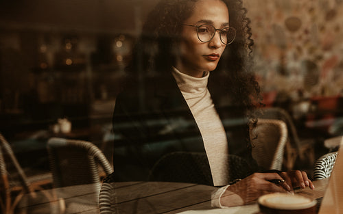 Businesswoman at cafe working on laptop