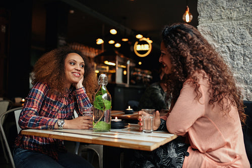 Young women sitting in a restaurant talking