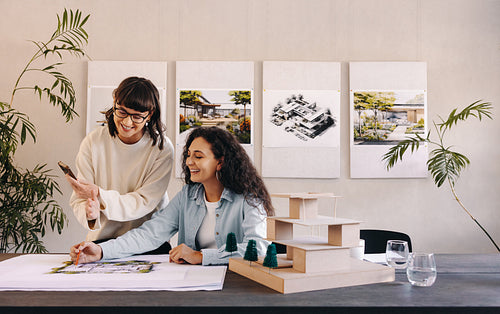 Architects collaborating on a project model in a professional workspace setting