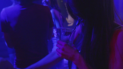 Couple dancing at the nightclub with friends around