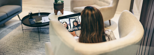 Anonymous businesswoman attending a video conference in a modern office